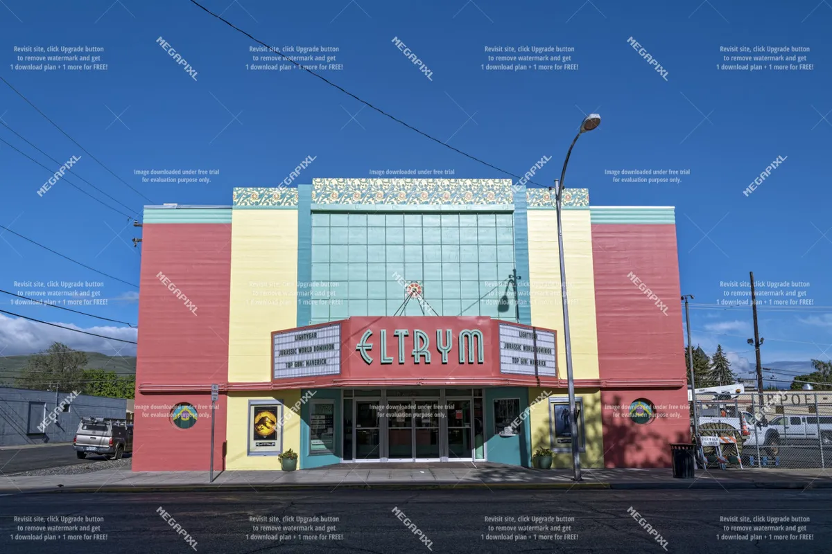 The exterior of the ELTRYM theater, featuring its iconic sign and bright, colorful facade. The scene evokes a sense of nostalgia and community, highlighting one of downtown Baker City's cultural landmarks.