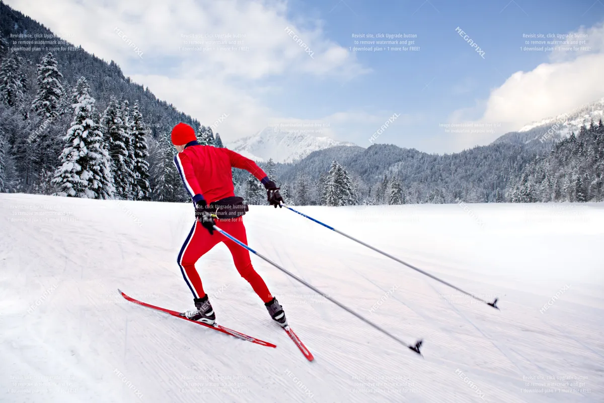 A skier glides through snow-covered trees with a striking mountain backdrop, capturing the energy and scenery of a winter sports destination.
